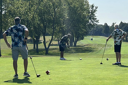 St Monicas Golf Outing - Three men out on the greens